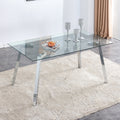 A modern minimalist rectangular glass dining table with tempered glass tabletop and silver metal legs, suitable for kitchens, restaurants, and living rooms,63'*35.4'*30'